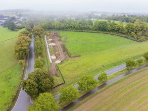 Aerial view of a construction site with roads and trees in a natural environment, Bau PV