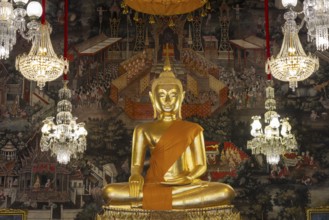 Golden Buddha statue, Phra Buddha Trilokachet surrounded by crystal chandeliers and exquisite wall