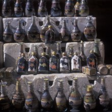 Souvenir stand, bottles filled with colorful sand, Nabataean rock town Petra, Jordan