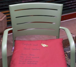 Cushion on chair with city advertising, Oberstadt, Marburg, Hesse, Germany