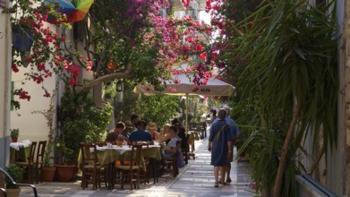 Old town of Nauplion, busy pedestrian street with blooming plants and seating areas, Nauplion,