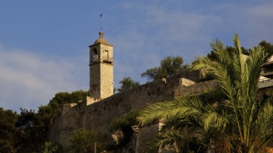 Stone tower with clock and palm trees under blue sky, Nauplion, Nafplion, Peloponnese, Greece