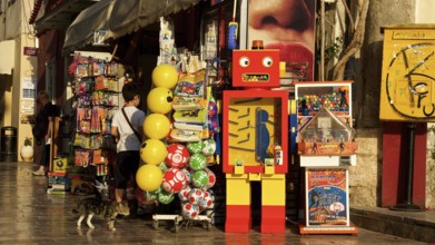 Old town of Nauplion, A colorful toy store with a retro robot and balloons in a sunny street,
