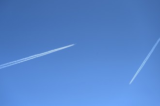 Two airliners with contrails in the blue sky, Bavaria, Germany