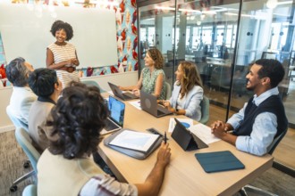 Diverse business colleagues actively participating in a positive meeting, listening to an african