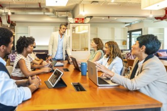 Diverse business professionals conducting a collaborative meeting in a contemporary open plan