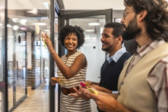 Diverse business professionals collaborating in a modern office, developing new strategies and