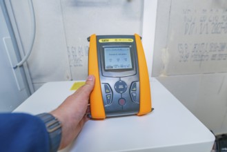 Person operates PVCheck PRO with a display that shows information