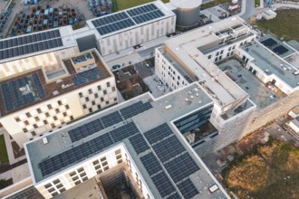 Aerial view of building roofs with solar systems and surrounding roads, new hospital, Calw Health