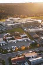 Aerial view of a building complex and industrial areas in autumn surroundings at sunset, new