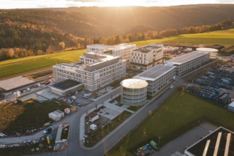 Aerial view of a modern building complex in rural area at sunset, new hospital, Calw Health Campus,