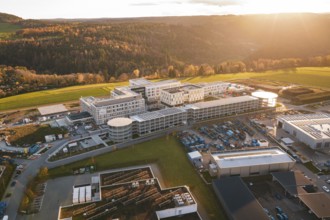 Aerial view of a large complex of buildings in autumn landscape at sunset, new hospital, Calw