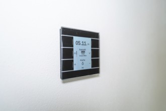 A switch with a display on a white wall