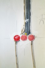 Three sockets built into the wall, new cable installation during renovation