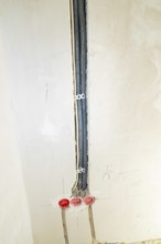 Black cable ducts inserted into the wall, prepared for electrical installation