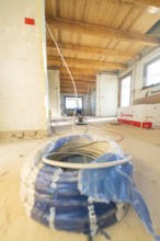 Cable reel and electrical material in a spacious attic during renovation work