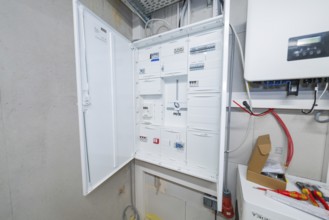 Detailed view of an electrical cabinet with open control boxes in the technical room