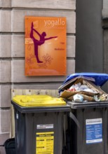 Overfilled trash cans at the entrance to a yoga school, Fulda, Hesse, Germany