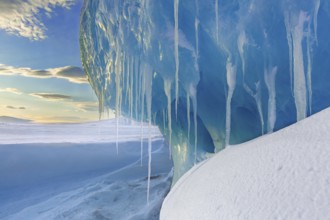 Melting icicles in snow covered Arctic landscape at Mohnbukta, bay at the western shore of