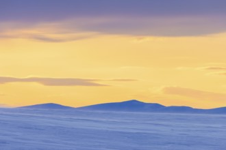 Snow covered mountains at midnight in Arctic landscape at Mohnbukta, bay at the western shore of