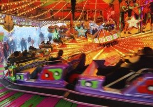 People on the Musik-Express ride at the All Saints Fair, the biggest old town fair in Europe,