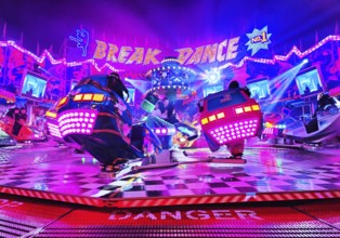 People in the colorful illuminated break dance ride at night at the All Saints Fair, Soest, North