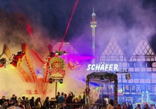 Colourful evening rides in front of half-timbered houses at the All Saints Fair, Altstadt, Soest,