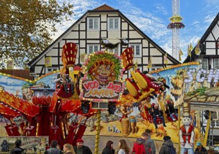 All Saints Fair ride in front of half-timbered houses, largest old town fair in Europe, Soest,