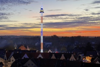 View from above from the Ferris wheel of the free fall tower at the All Saints Fair in the evening,