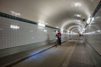 Interior view, pedestrians and cyclists crossing tunnel, mopping effect, movement, tube, historic
