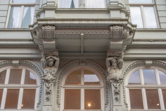 Caryatids at the bottom of a bay window in a historic residential building, 19th century, Hanseatic