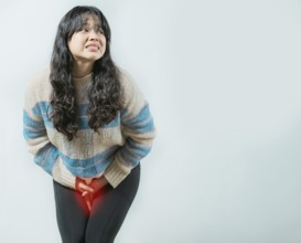 Medical problem urinary incontinence. Asian young woman with urinary problems, Female with hands on