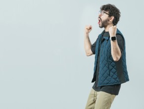 Happy guy with sunglass celebrating something. Excited young man celebrating looking at camera