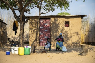 Locals in a typical village with clay huts, Caprivi Strip, Namibia