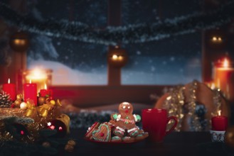 Cosy Christmas atmosphere with candles, gingerbread man and a winter view