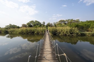 Toruist on the Kavango River, suspension bridge at Camp Kwando, Zambezi region, Caprivi Strip,
