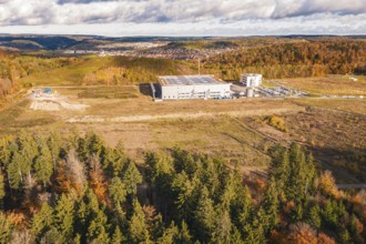 Large industrial complex in autumn, nestled in a hilly landscape, new Lindenrain industrial park,