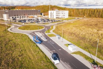Modern architecture with street, parking lot and surrounding autumn landscape, new Lindenrain