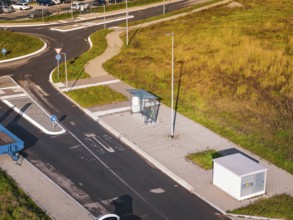 Bus stop on a road in a modern autumn landscape, new Lindenrain industrial park, Calw, Black