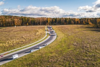 Street with motorhomes in extensive autumn landscape with trees, new Lindenrain industrial park,