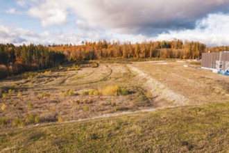 Open autumn landscape with wooded areas and dramatic skies, new Lindenrain industrial park, Calw,
