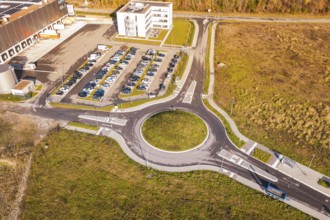 Roundabout and buildings in an autumn environment from the air, new Lindenrain industrial park,