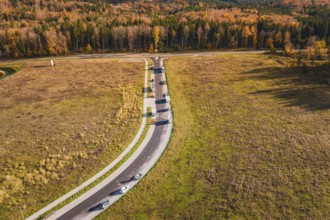 Intersection with moving cars in an open autumn landscape, new Lindenrain industrial park, Calw,