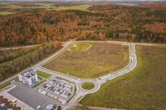 Aerial view of a roundel with surrounding buildings and autumn trees, new Lindenrain industrial