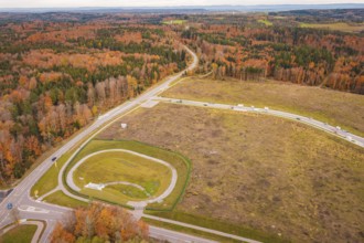 Extensive autumn landscape with crossroads surrounded by forests, new Lindenrain industrial park,