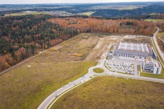 Industrial area with modern building on the edge of the forest and autumn landscape, new Lindenrain