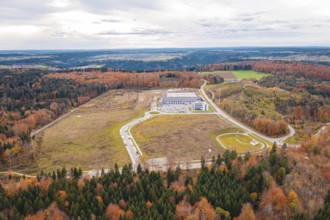 Industrial plant surrounded by extensive autumn landscape with forests and roads, new Lindenrain