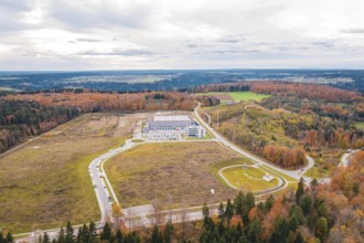 Large industrial area surrounded by forests and roads in an autumnal atmosphere, new Lindenrain