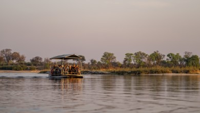 Boat trip, tourists in a boat on the Okavango River, Caprivi Strip, Namibia