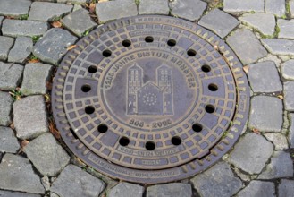 Manhole cover, manhole cover with the cathedral, cobblestones, Münster, Münsterland, North